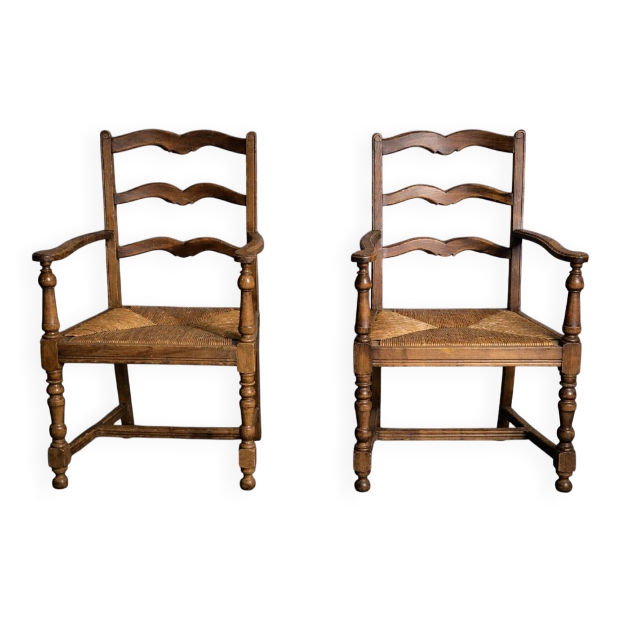 Pair of rustic antique armchairs in wood and woven straw.
