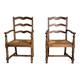 Pair of rustic antique armchairs in wood and woven straw.
