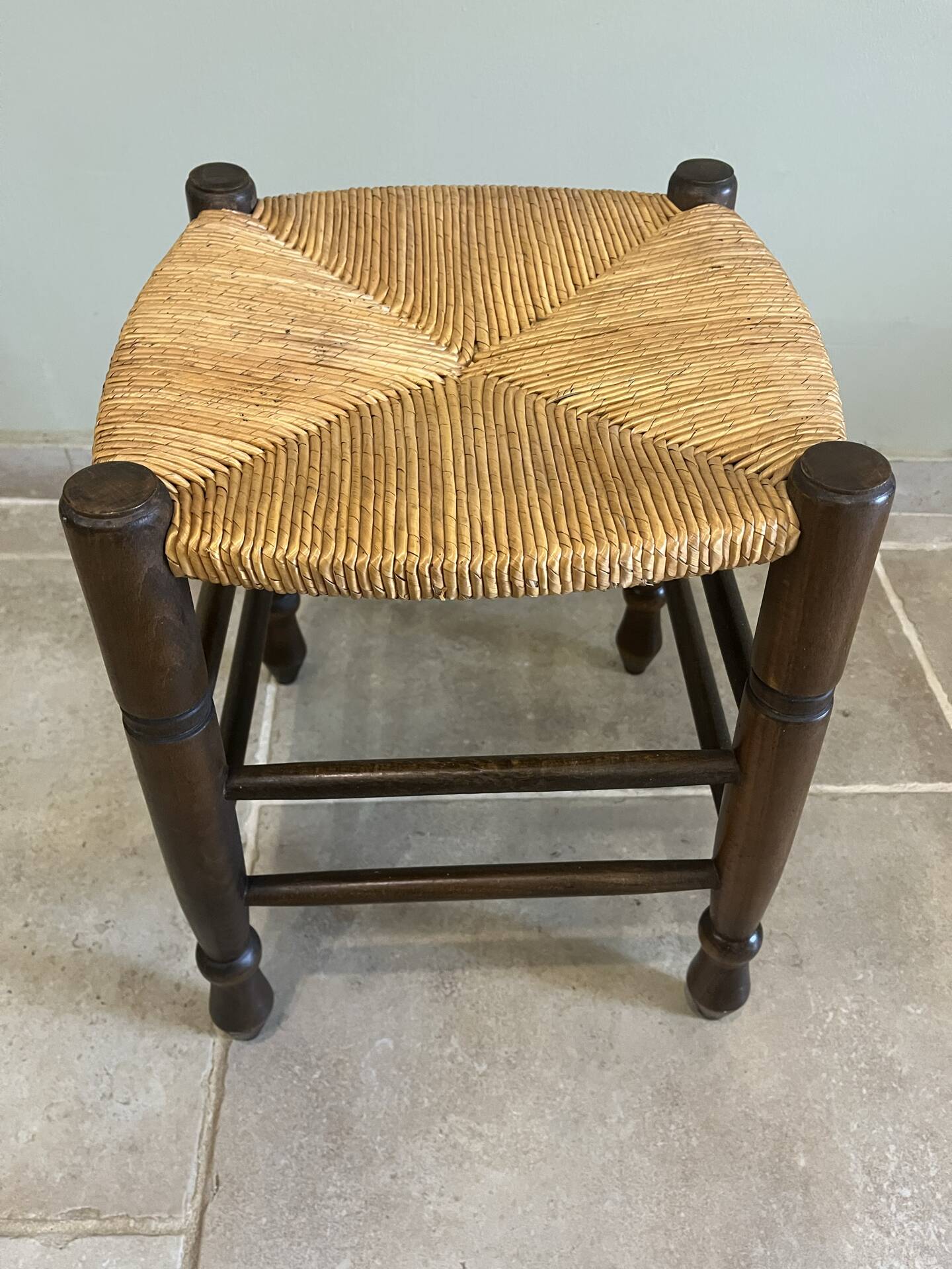 Wooden stool with a straw seat