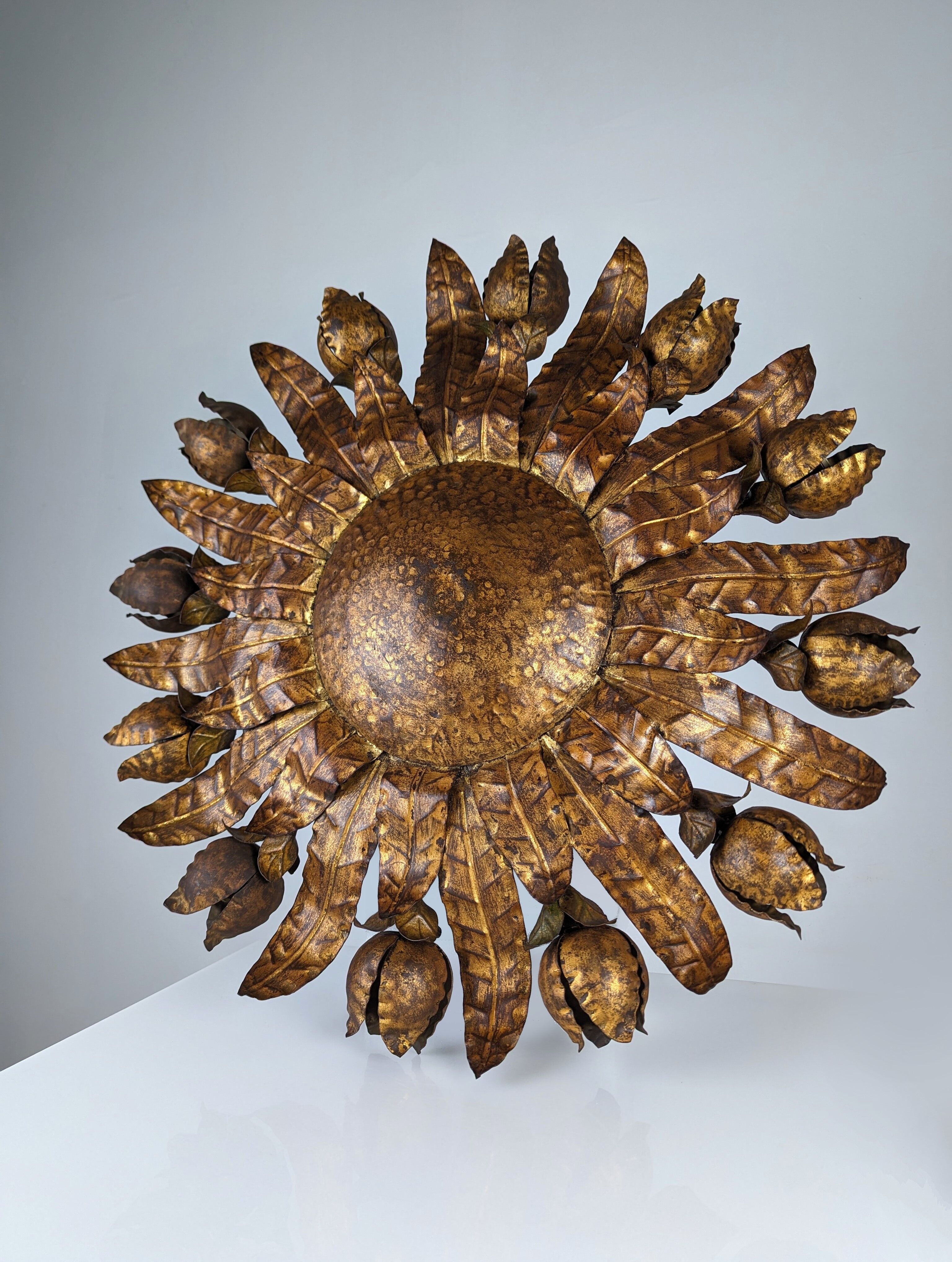 Large mid-century sunburst ceiling lamp, gilded metal with floral motif, 1950s
