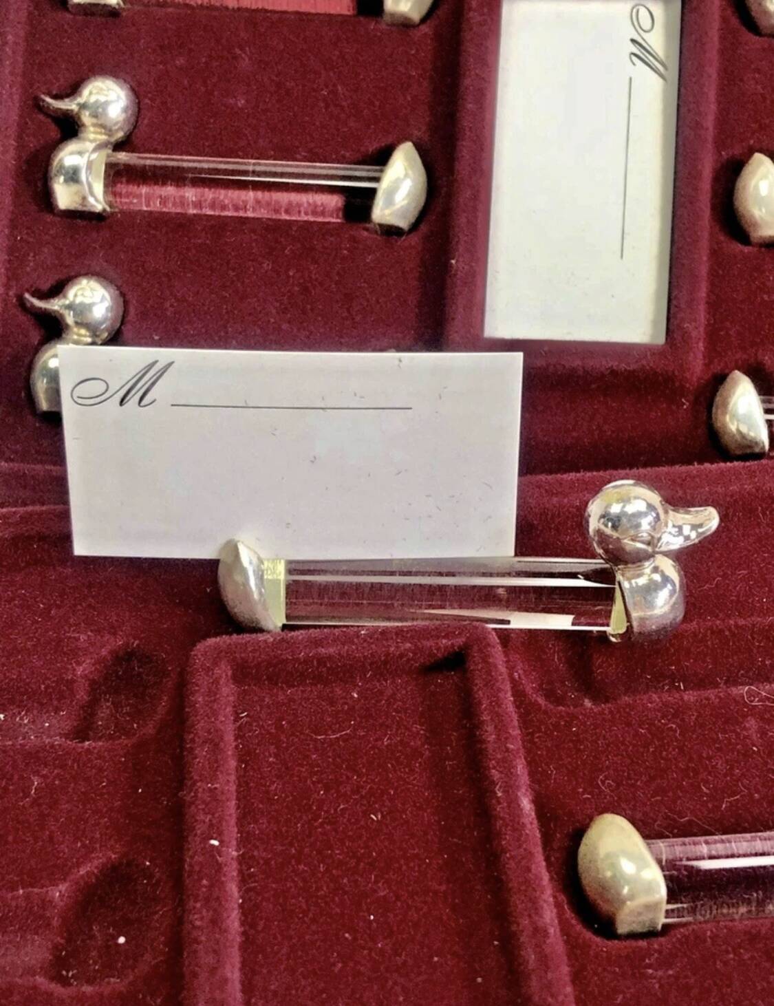 12 silver-plated metal duck knife rests with crystal.