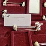 12 silver-plated metal duck knife rests with crystal.