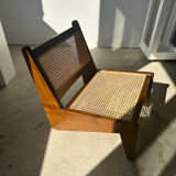 Reclined armchair in canned teak in natural wood