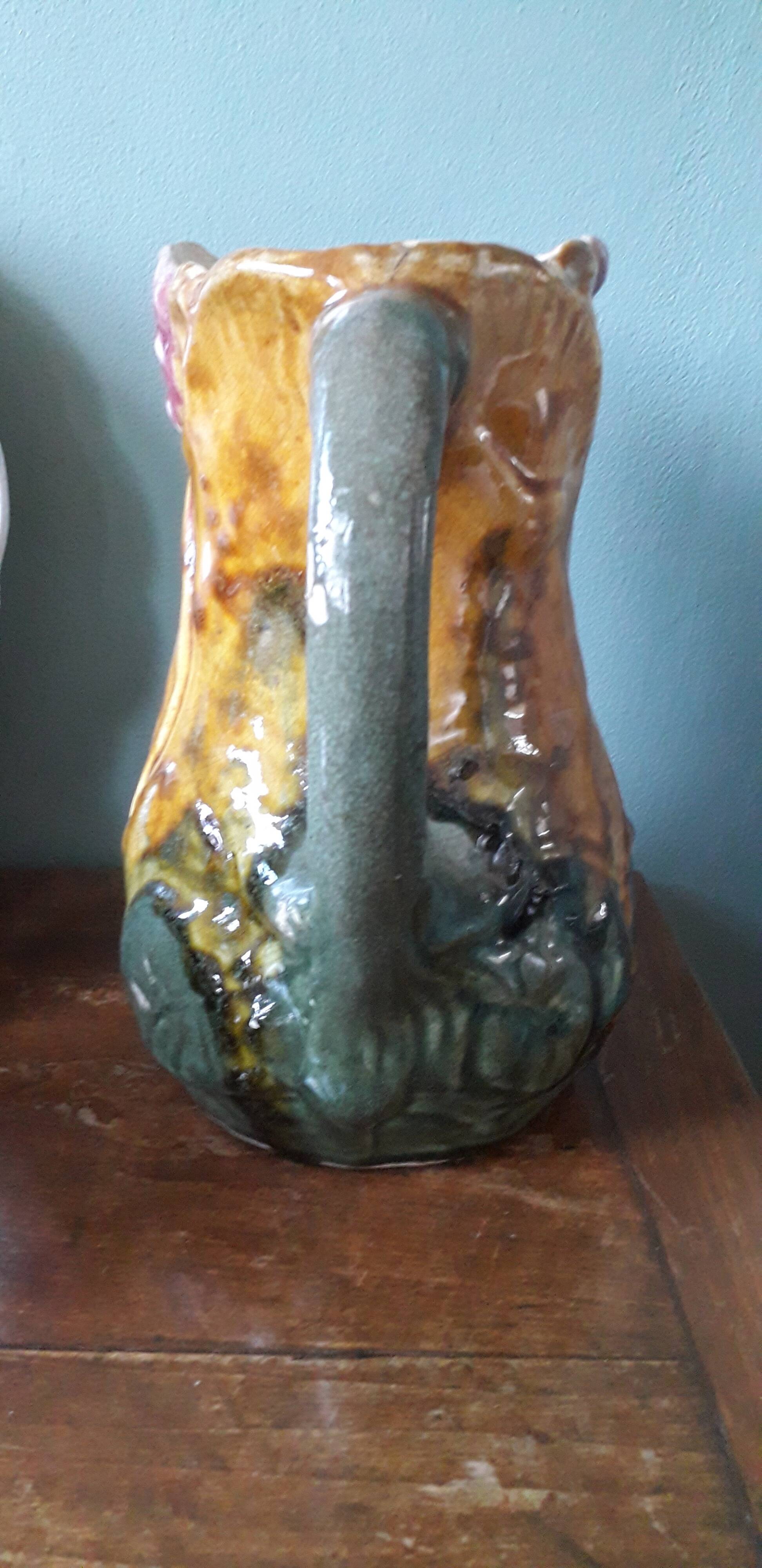 Vintage barbotine pitcher with floral decoration