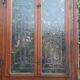Oak entrance door and its frame and transom, wrought iron gates