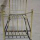 Antique gold-plated brass bed for one person.