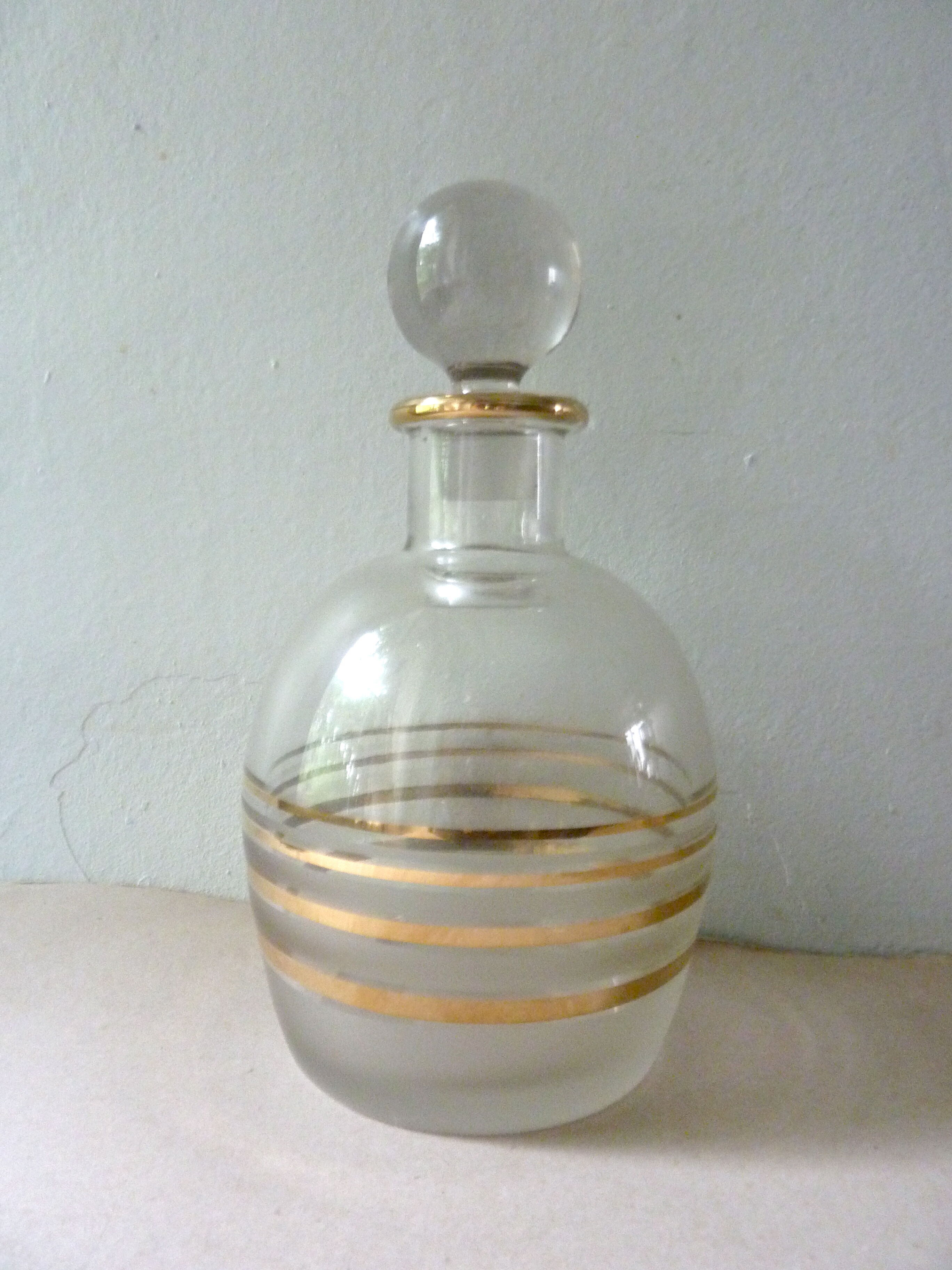 Pair of glass whiskey decanters with gold edging