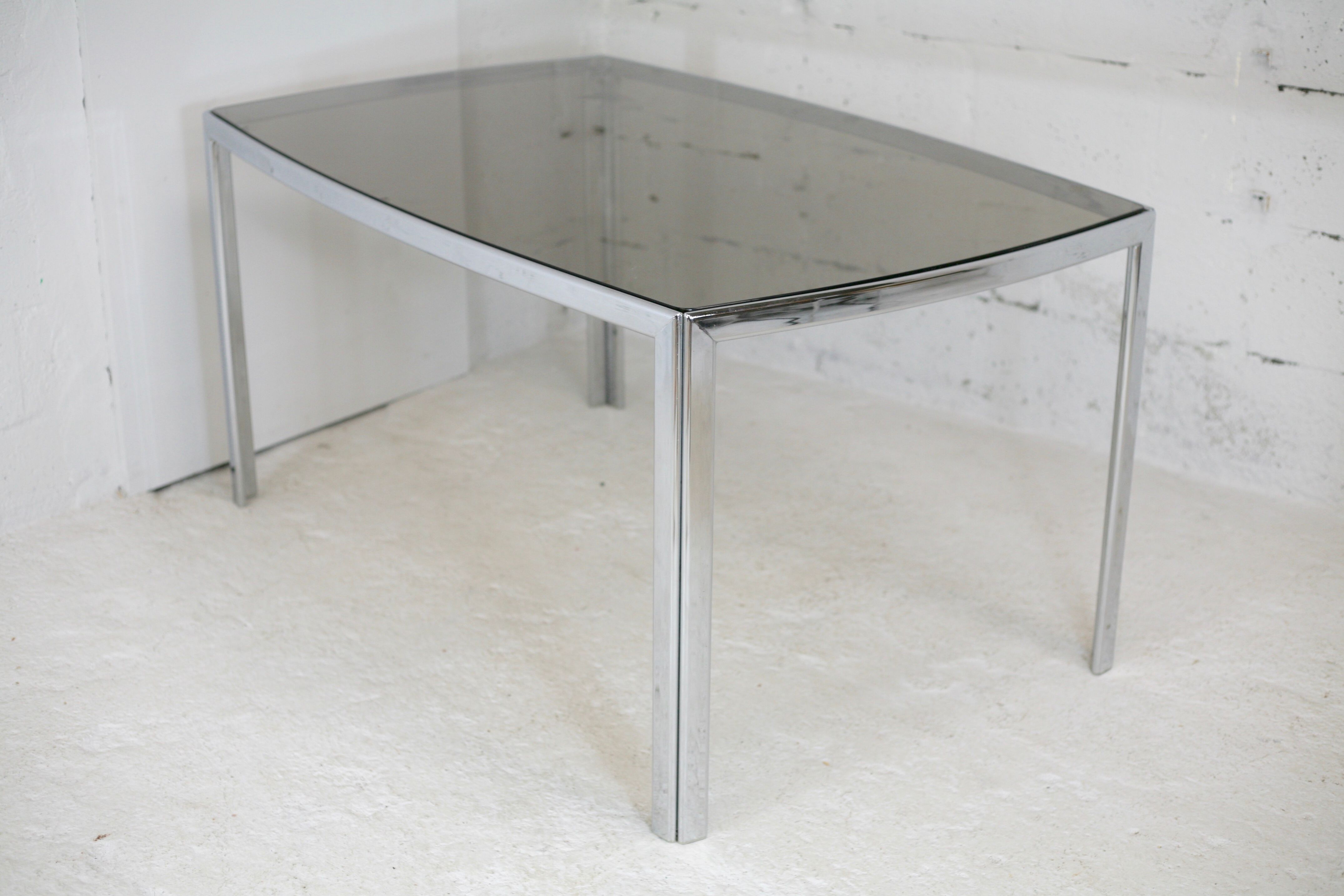 Living table. chrome metal, curved smoked glass slab, france, circa 1970.