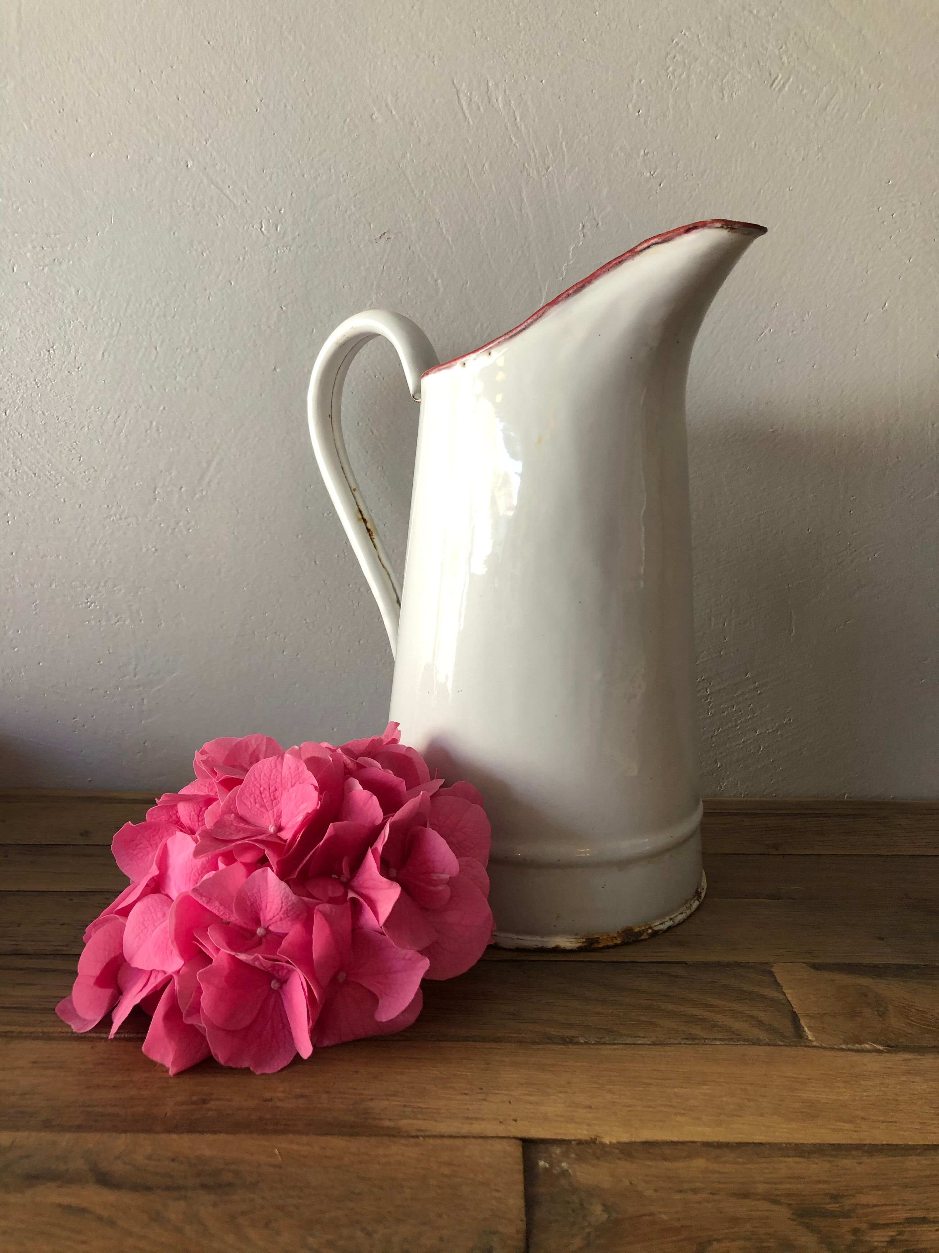 Old pitcher in enamelled sheet metal