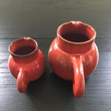 Pair of red pitchers
