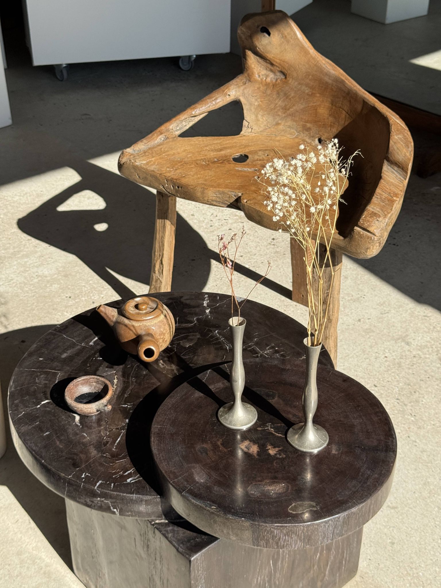 Brown petrified wood coffee table from Indonesia with a double circular top.