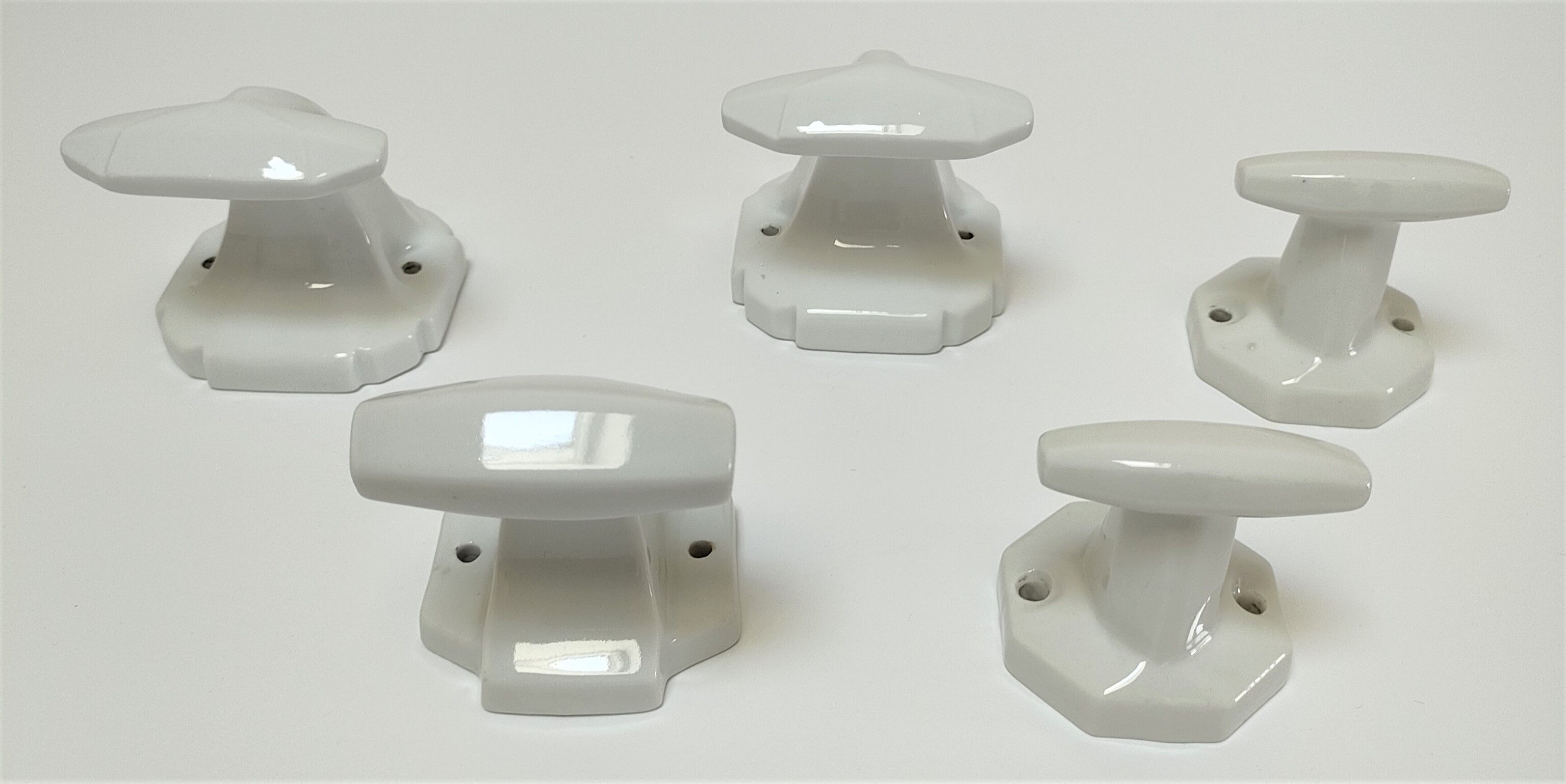 Five art deco white porcelain hooks