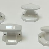Five art deco white porcelain hooks