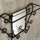 Wall-mounted coat rack with its mirror.