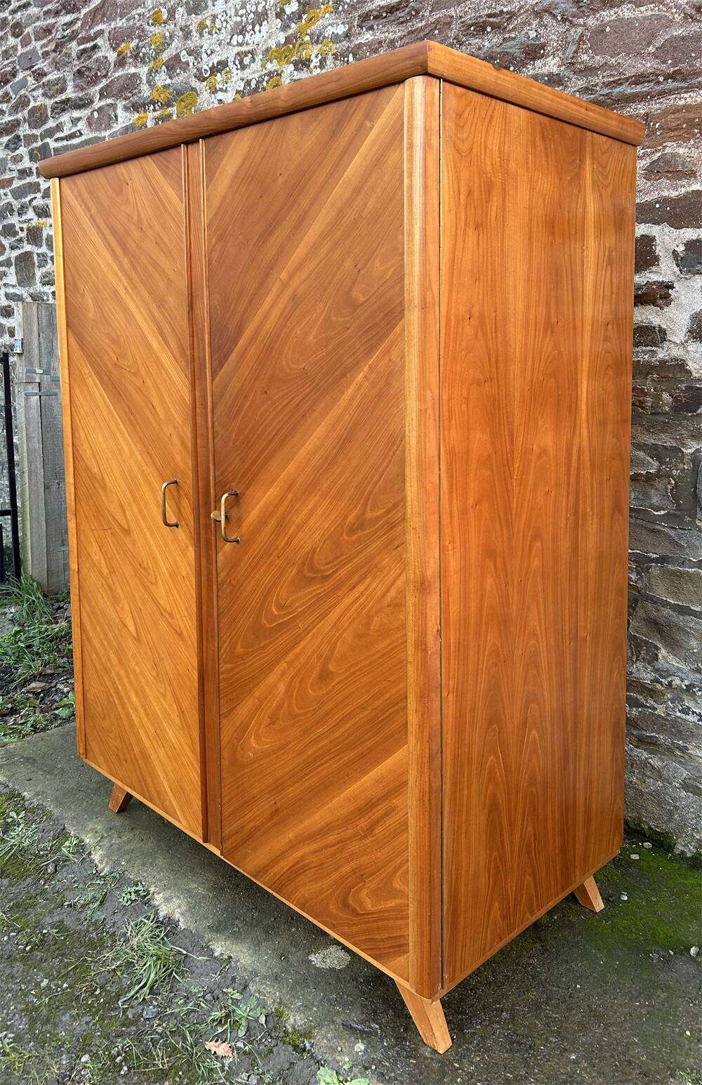Mid-century wardrobe from the 1960s in wood, with a chevron front and tapered legs.