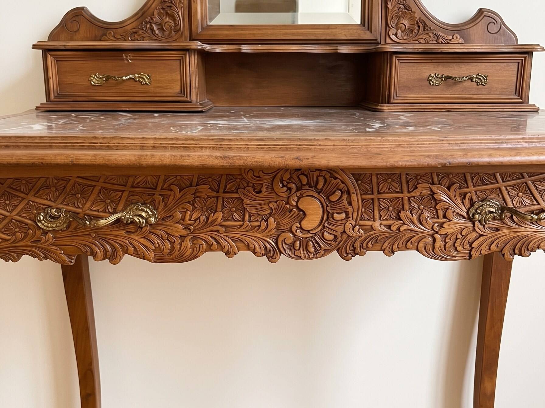 Antique carved wooden dressing table with marble and mirror.