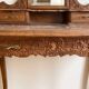 Antique carved wooden dressing table with marble and mirror.