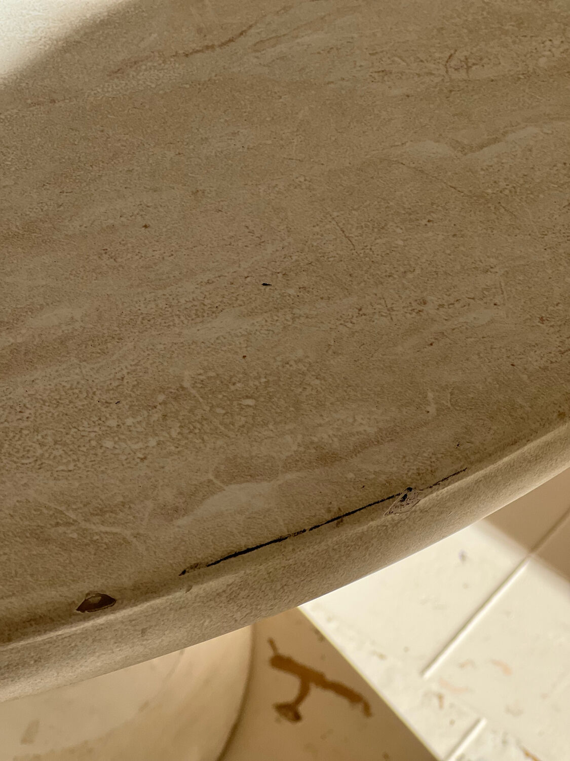 Travertine-effect stone dining table