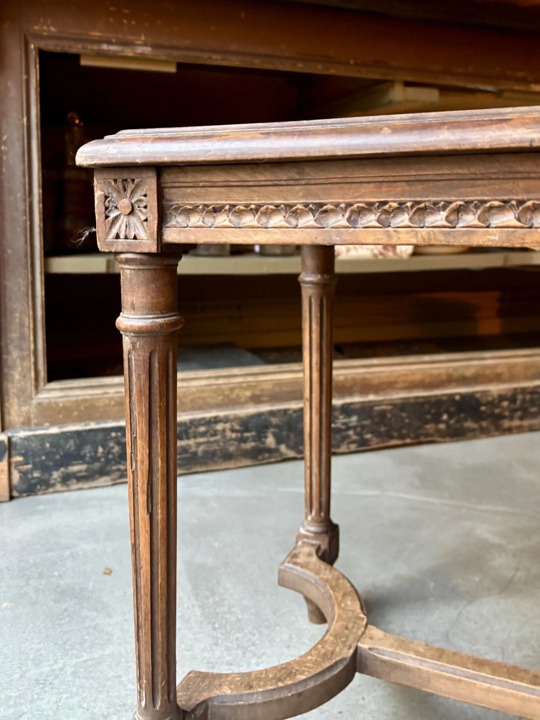 Stool, small wooden piano bench with carved details and caning.