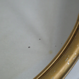 Oval mirror in gilded wood