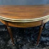 A Louis XVI period mahogany half-moon table forming a console/games table