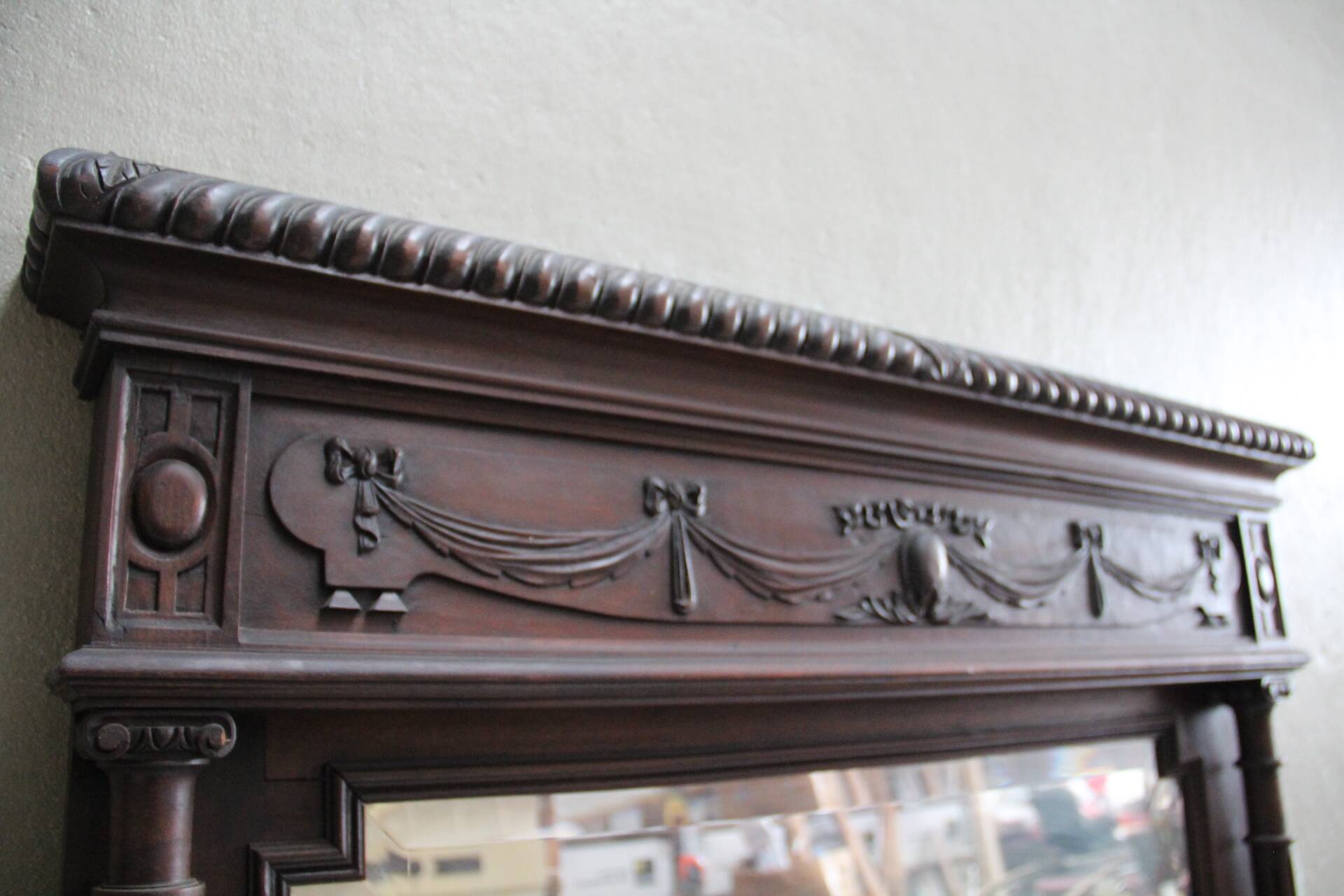 Imposing beveled mirror with wooden frame