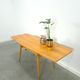 Vintage veneer table with pretty angular legs and brass at the base of the legs.