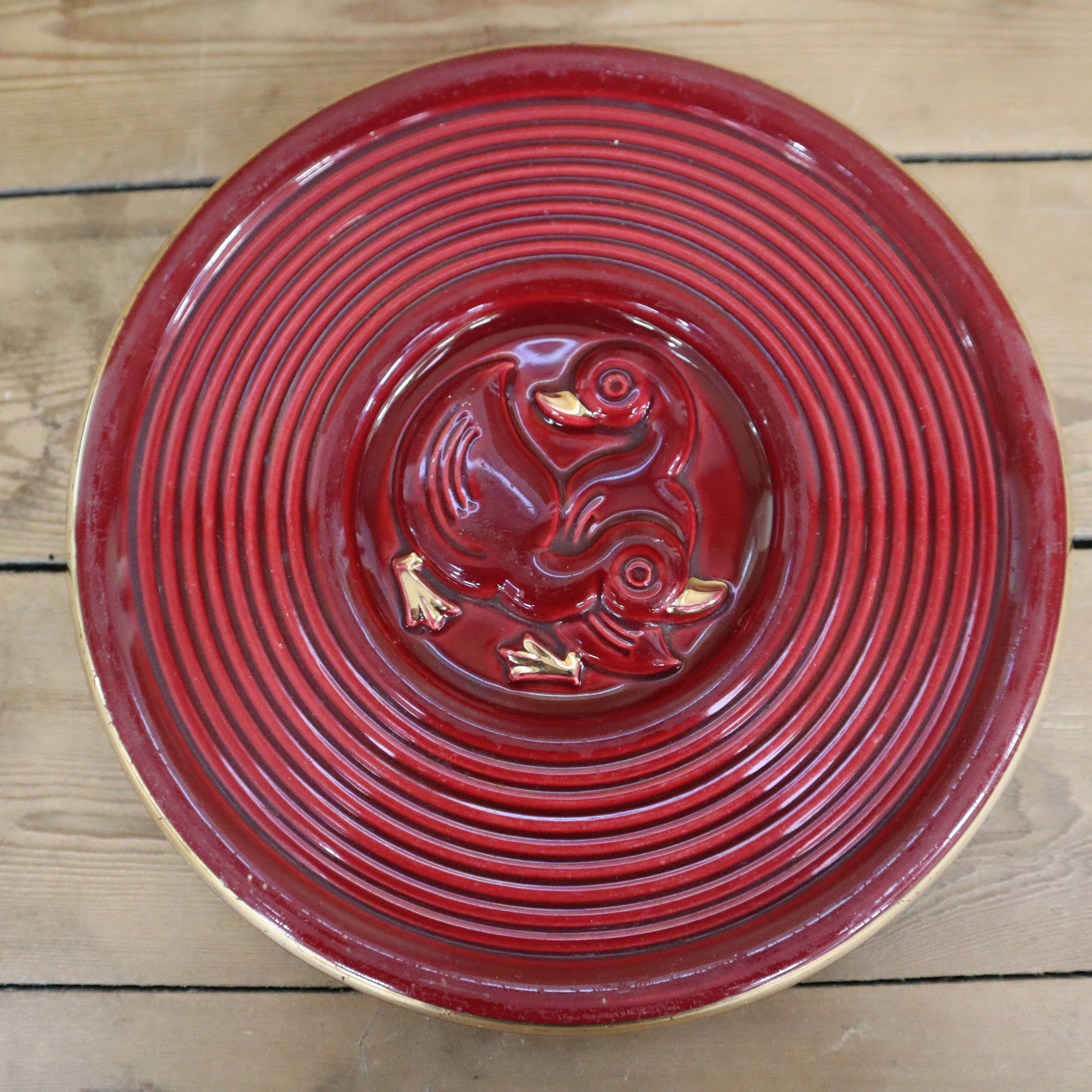 Vintage burgundy duck trivet with gold edging