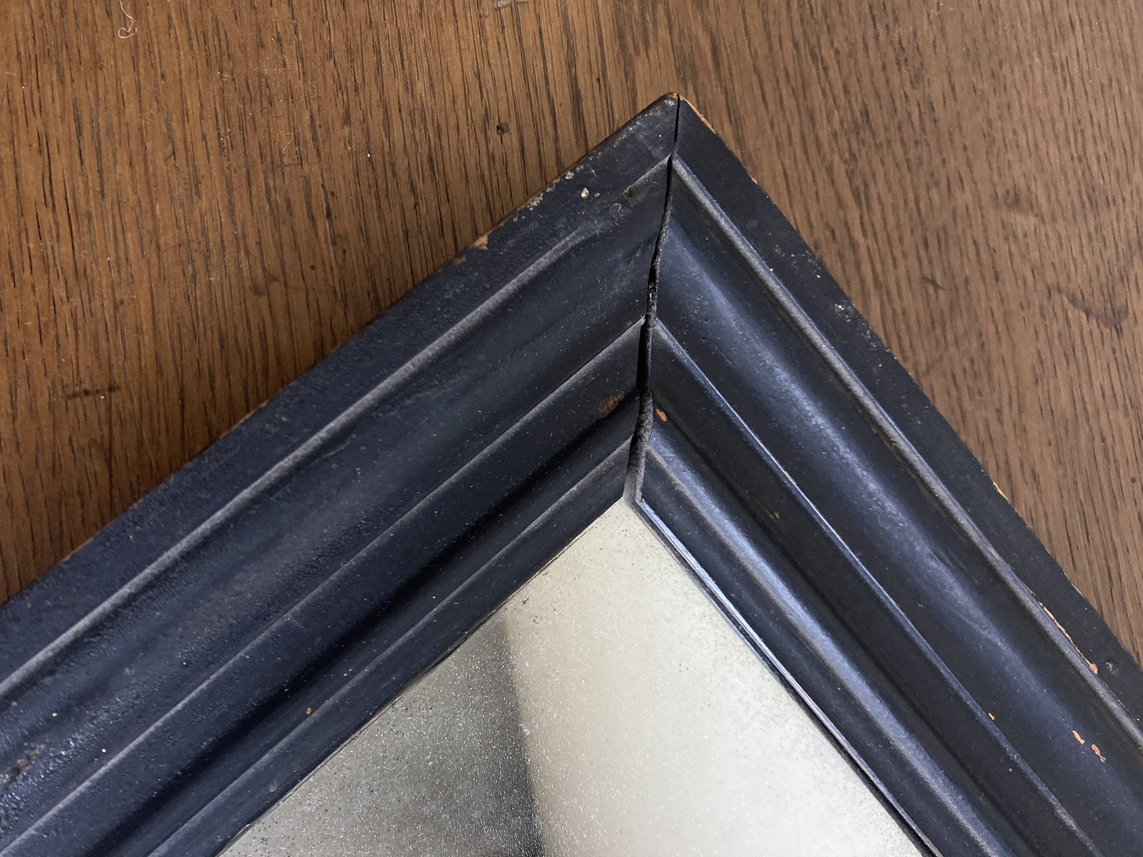 19th century blackened mirror with pitted glass 34cm x 40cm