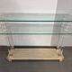 Hollywood Regency console style in travertine, glass, and Lucite.