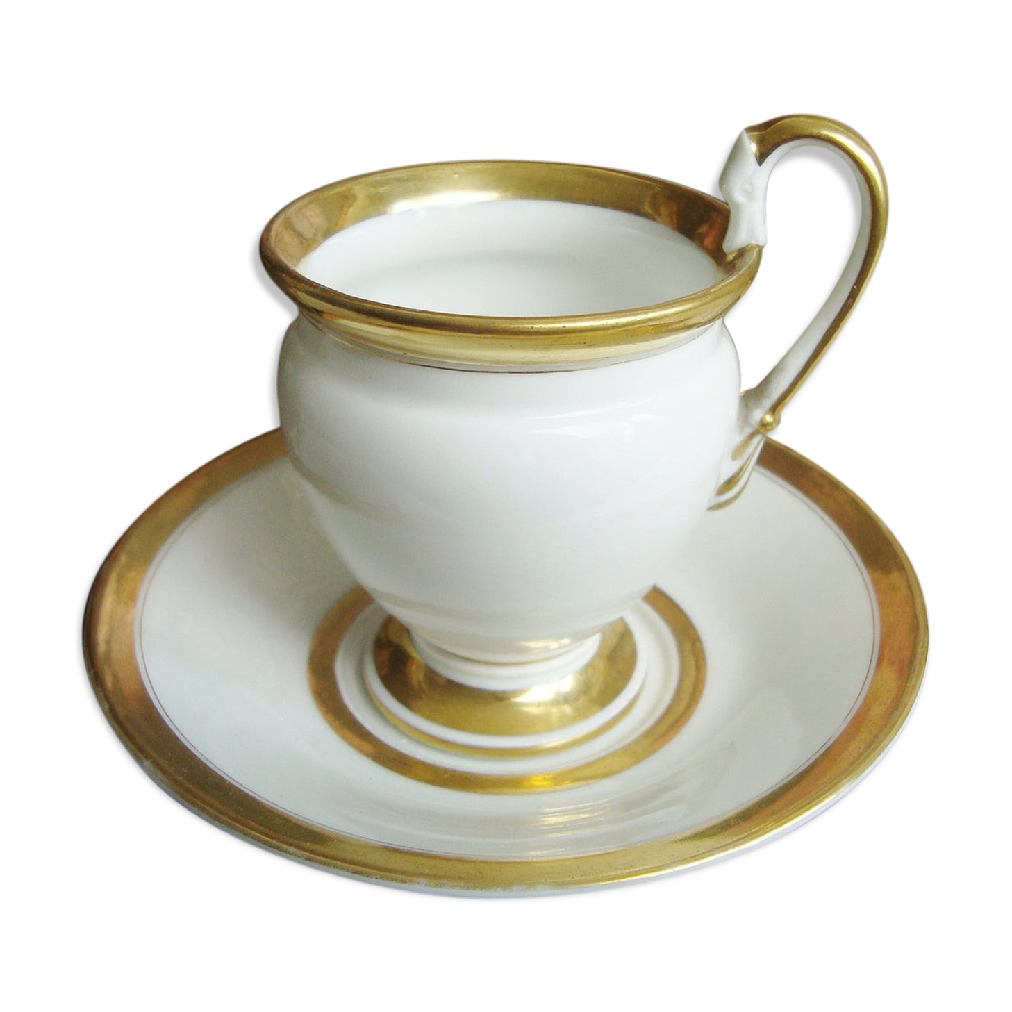 Tasse et soucoupe ancienne en porcelaine blanche et or XIXème avec poignée forme tête de cygne