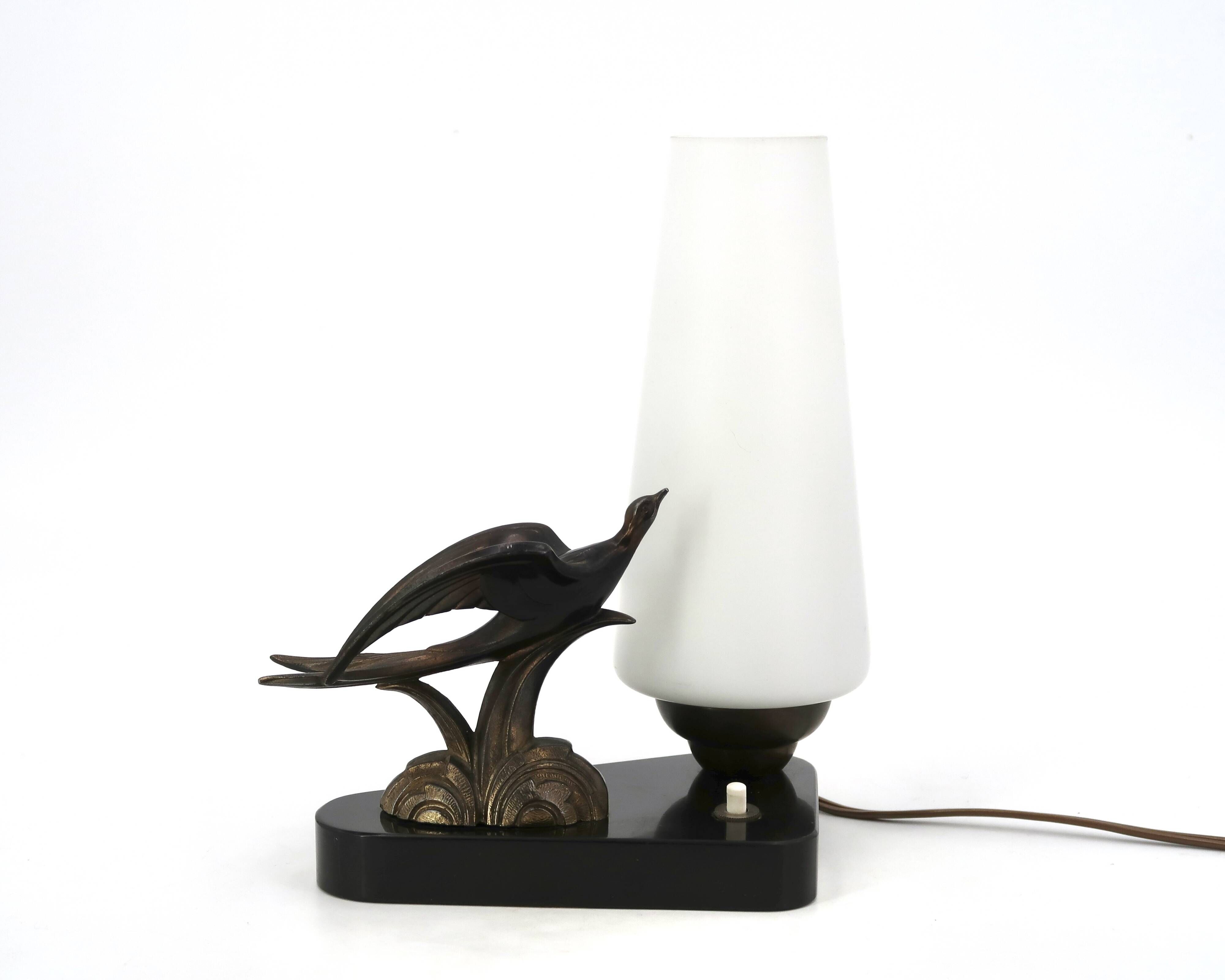Art Deco lamp with swallow sculpture, marble base, opaque white globe.