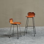 Set of 2 stools "Les Arcs" selected by Charlotte Perriand in leather.