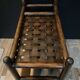 Vintage rattan magazine rack on wheels