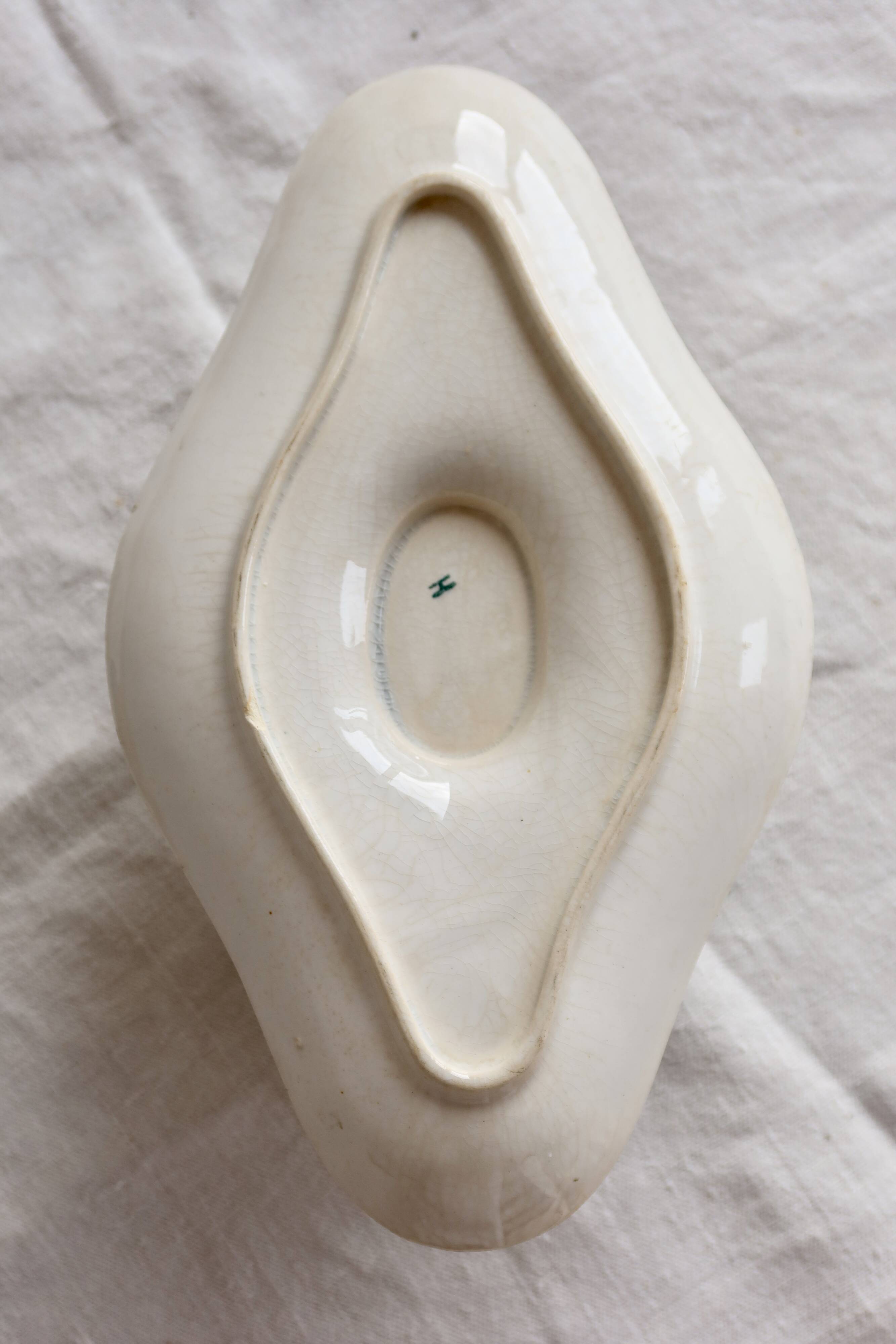 Antique sauce boat, ironstone, ivory with green floral and butterfly decoration.