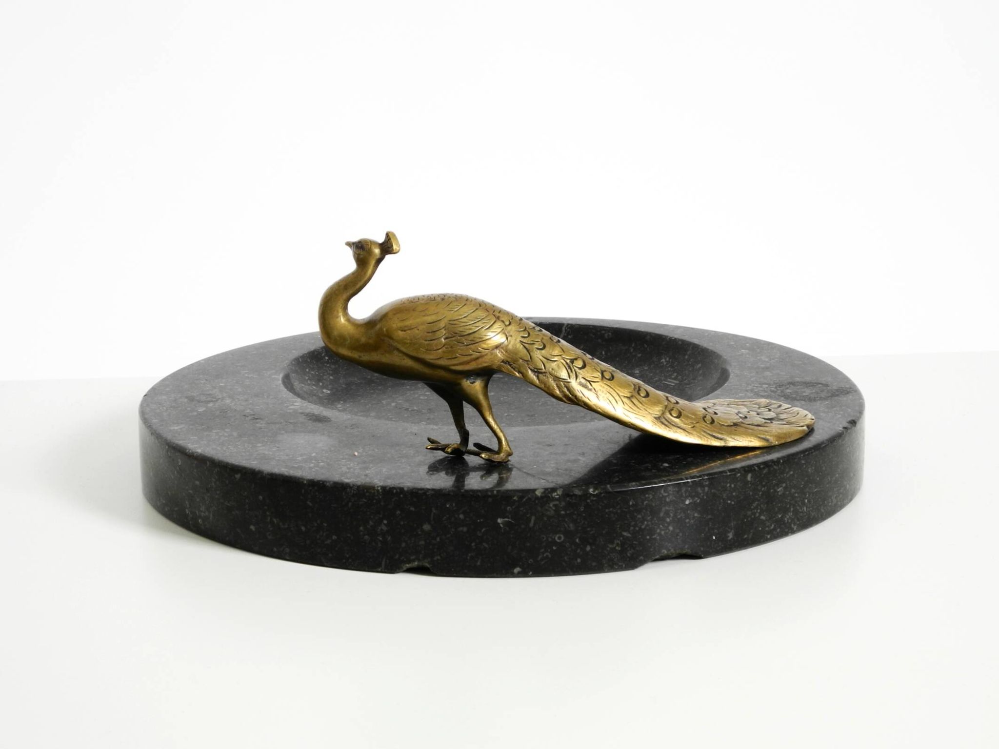 Beautiful, large black granite valet tray featuring a brass peacock, circa