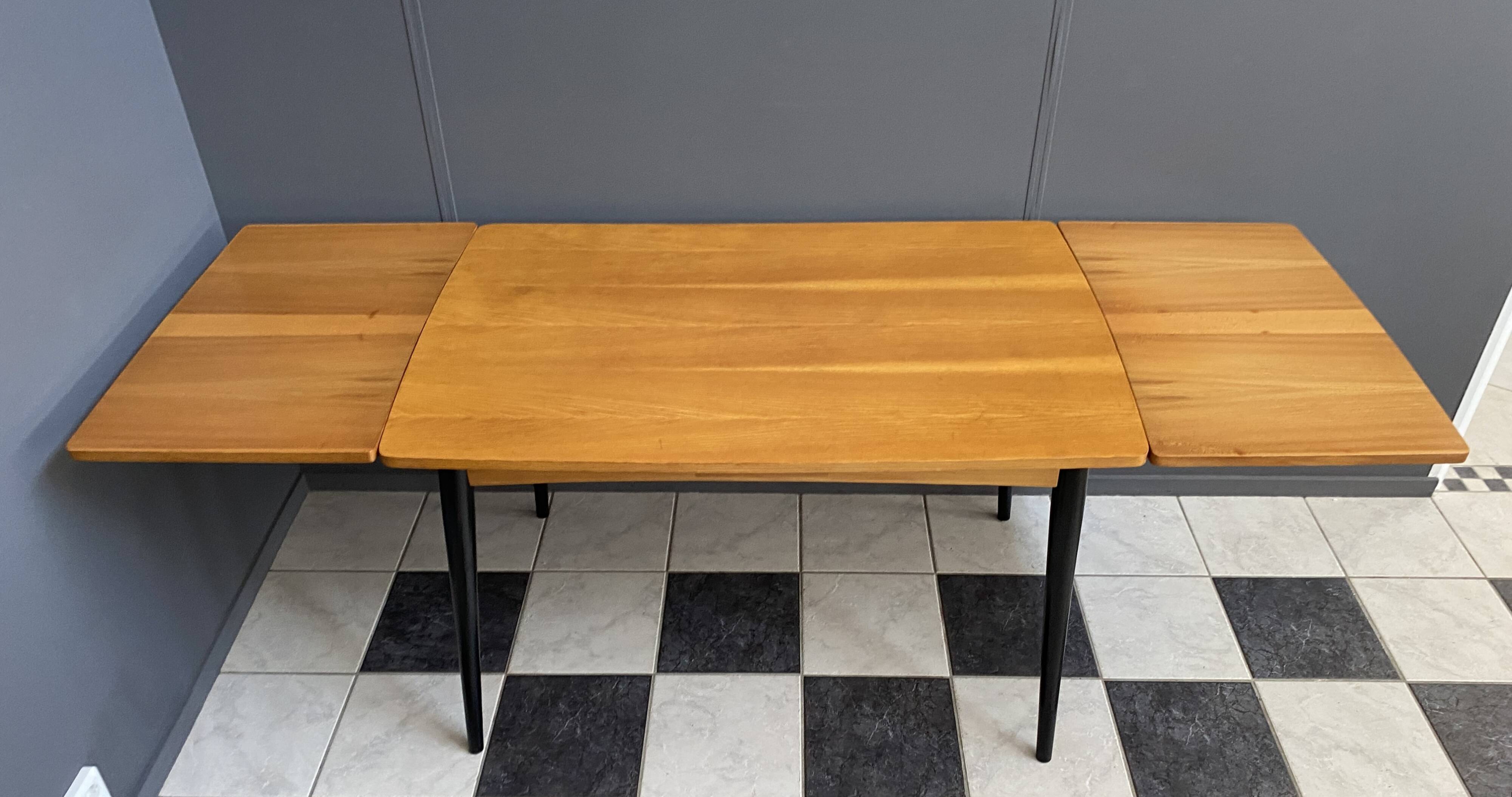 Wood enlarging dining table black wood legs 1960s