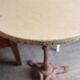 Cast iron base side table with a stone-effect top.