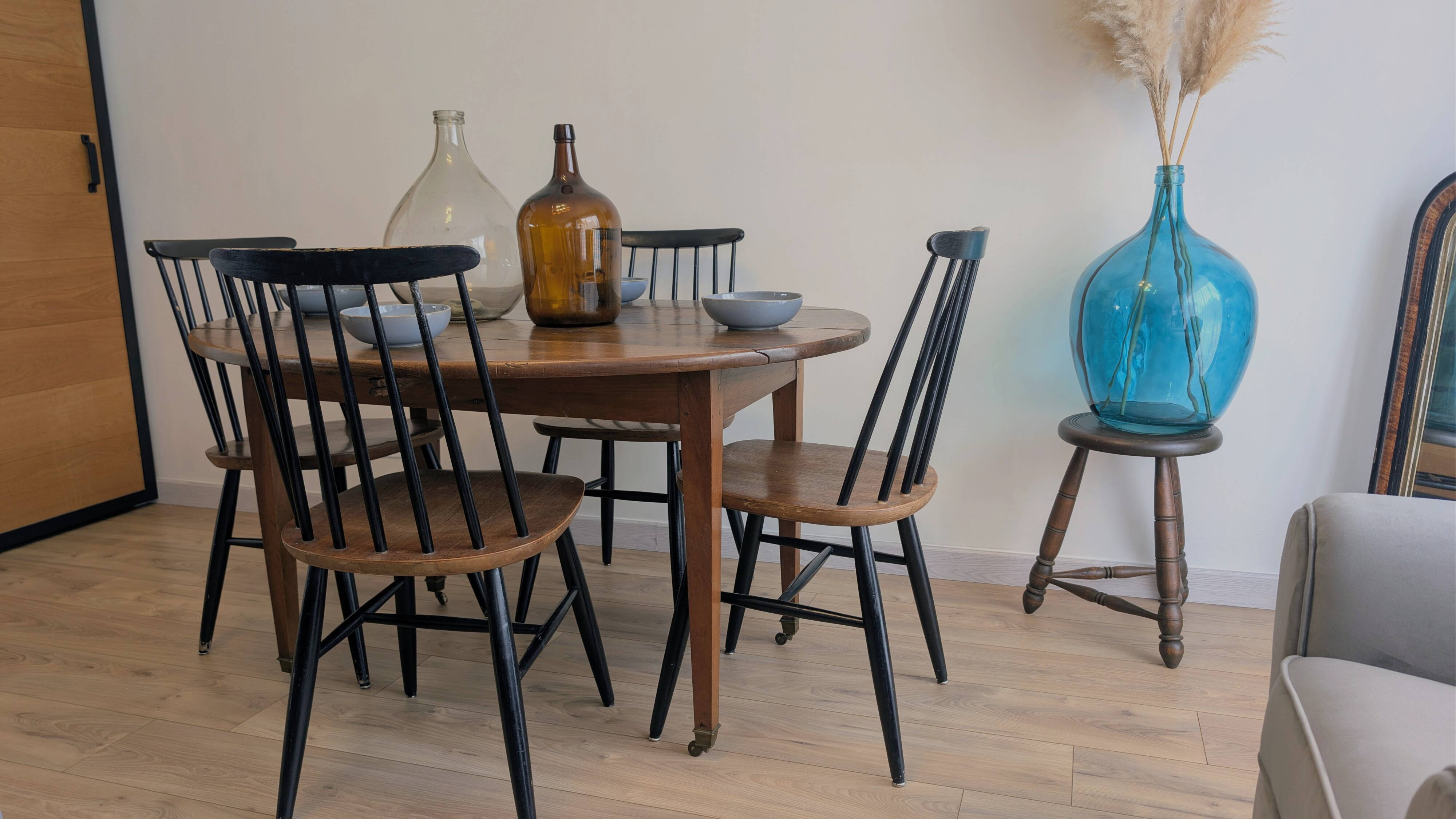 Antique wooden folding table with a patina and brass wheels.