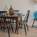 Antique wooden folding table with a patina and brass wheels.