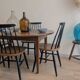 Antique wooden folding table with a patina and brass wheels.