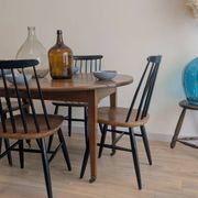 Antique wooden folding table with a patina and brass wheels.