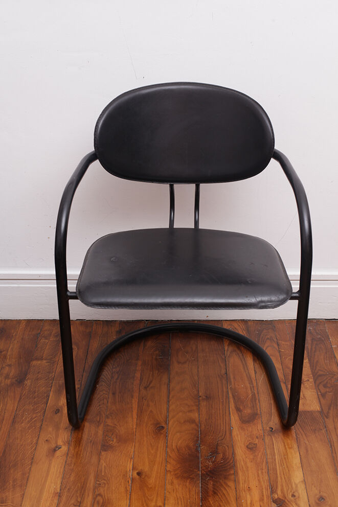 Black armchair with arched legs