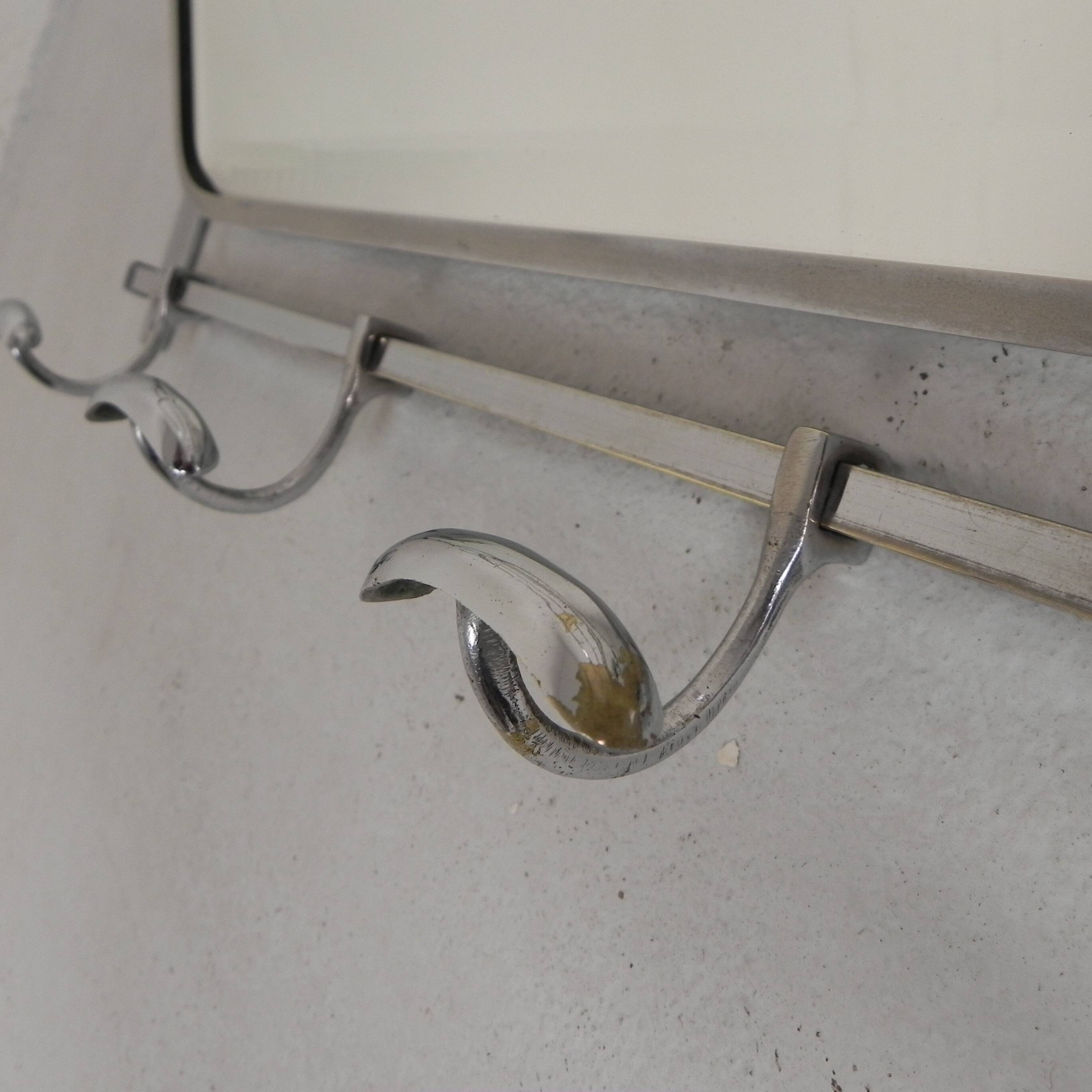 Art Deco wall coat rack with a bevelled mirror adjustable in a chrome frame, 1930s.