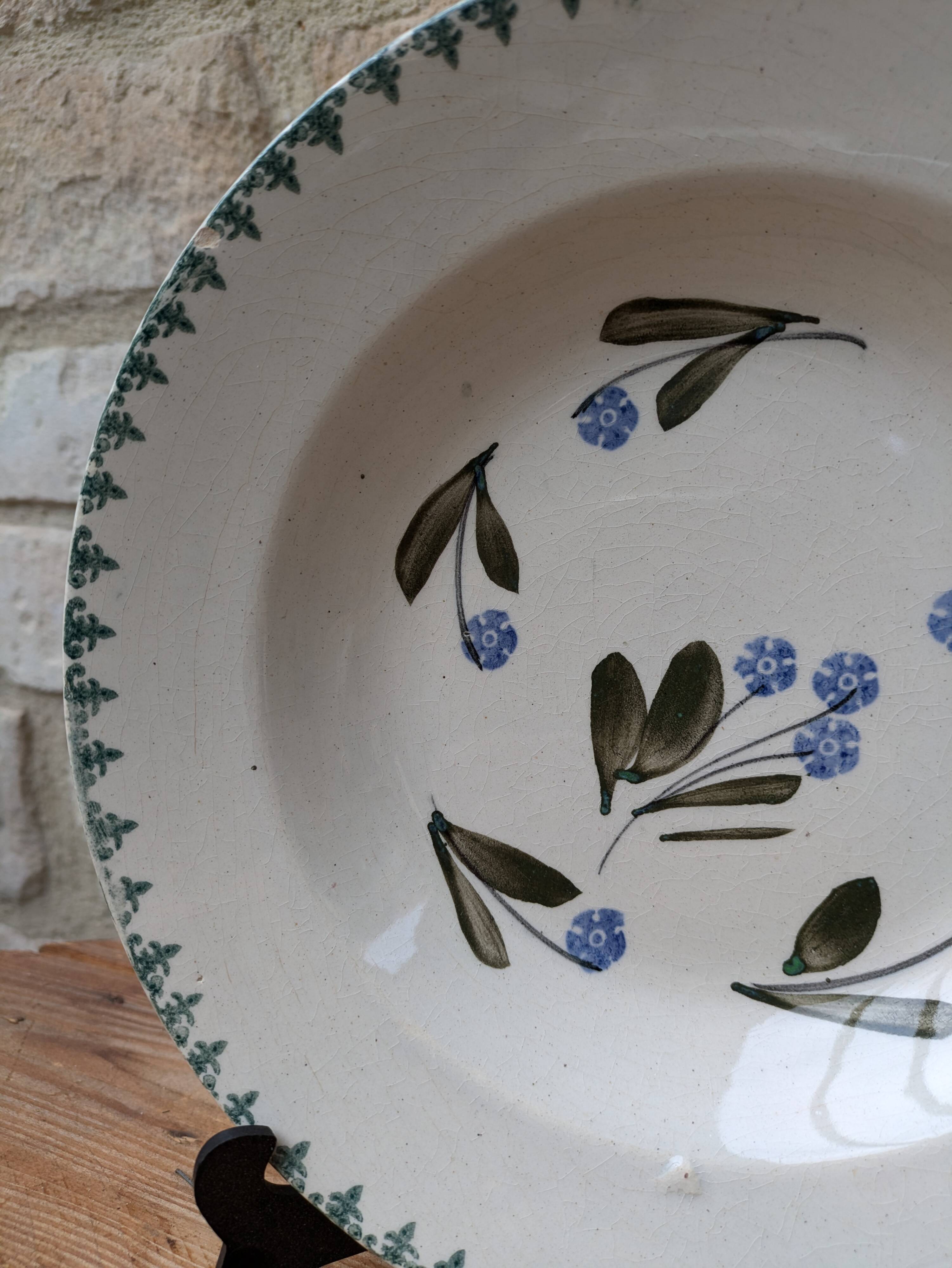 Old deep iron earth plate with blue flower pattern