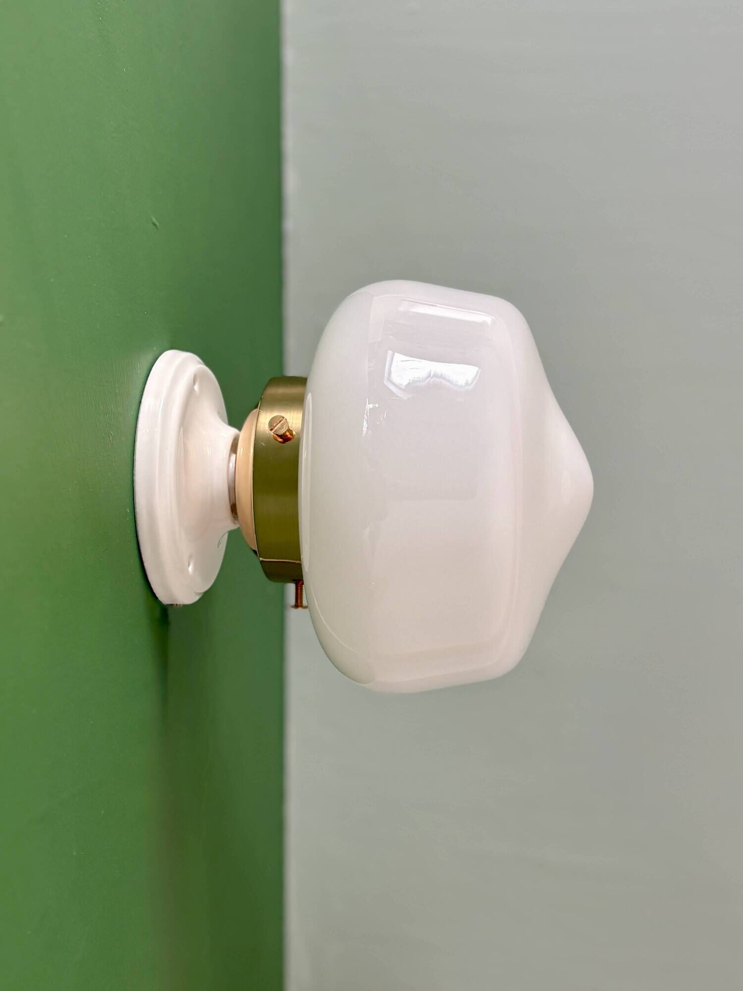 Vintage Art Deco globe wall light in white opaline.