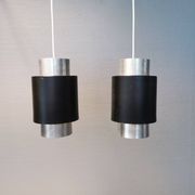 A set of beautiful cylinder shaped hanging lamps in silver color with black "ring" Danish 1970s.
