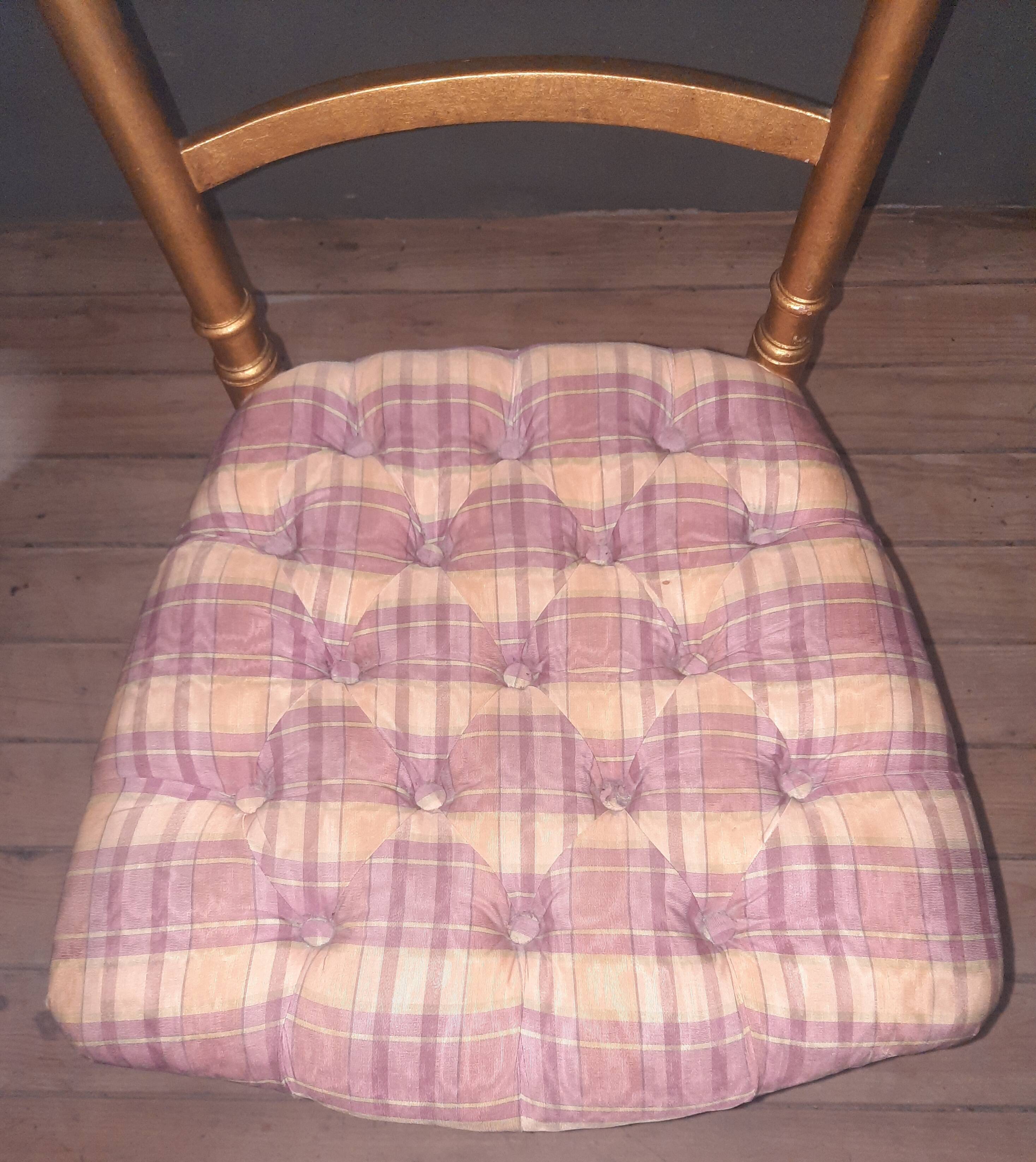 Pair of upholstered chairs in gilded wood