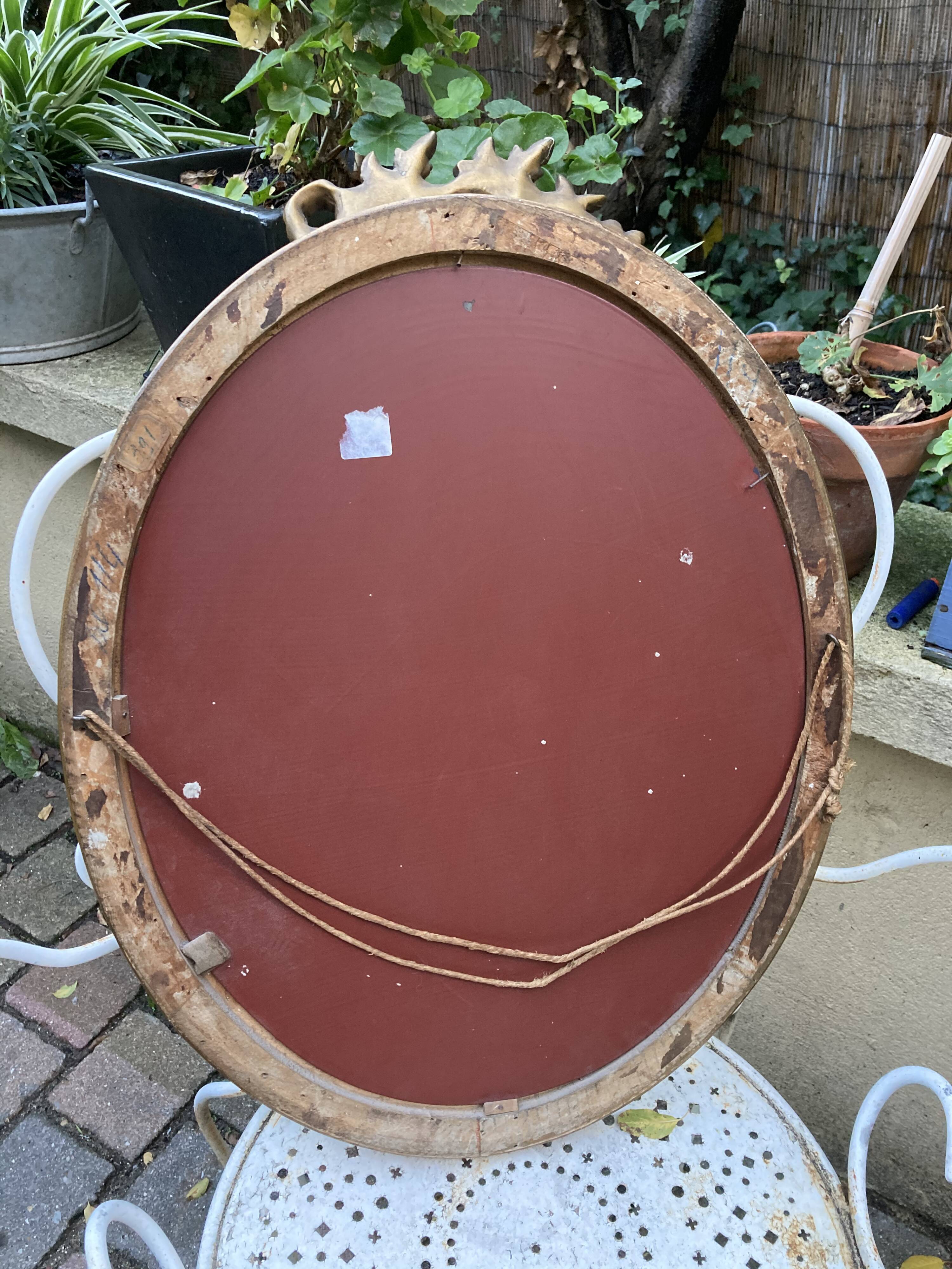 Bevelled oval mirror in vintage gilded wood 46x62cm