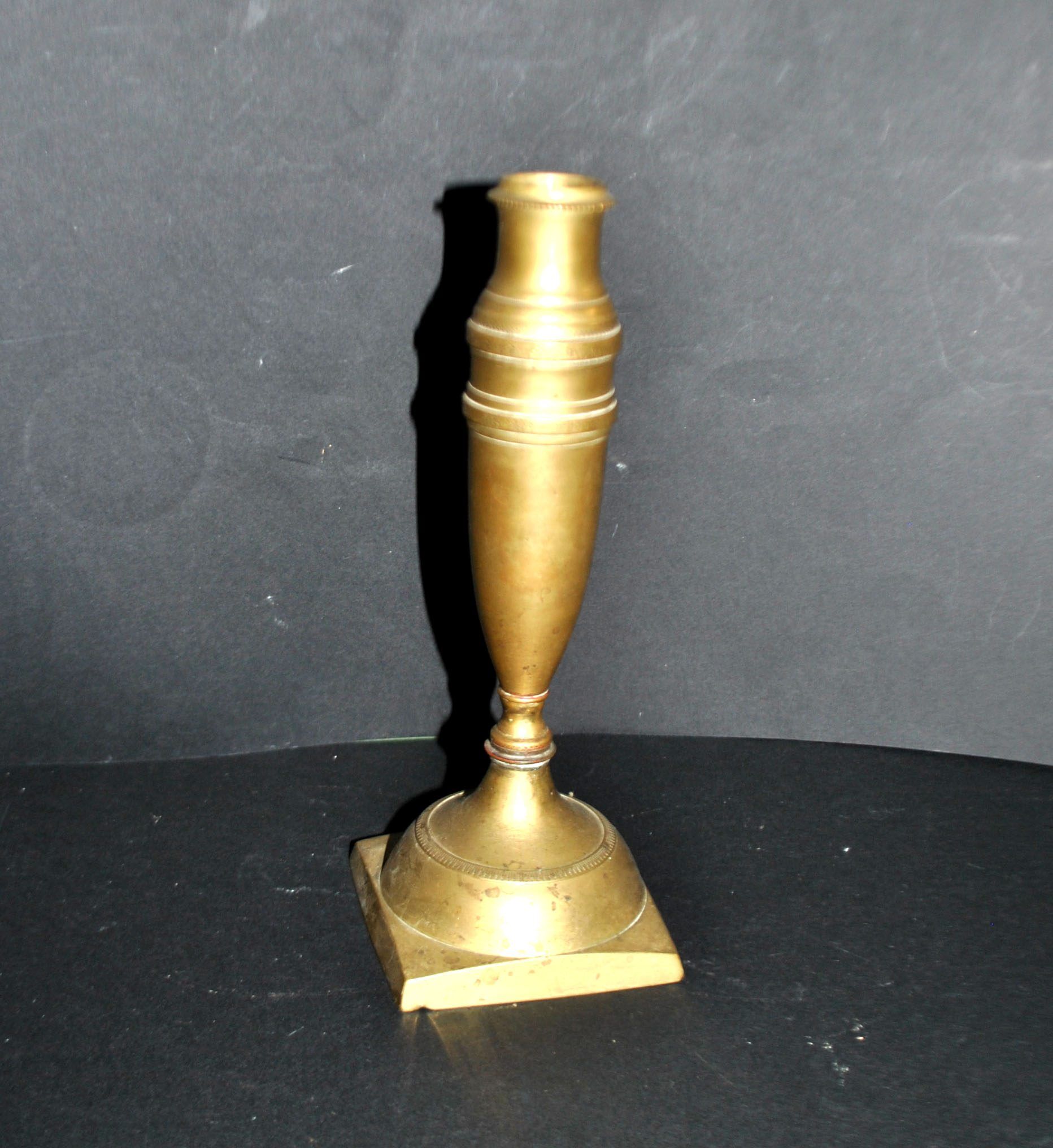 Antique baluster candlestick in bronze with hand-chiseled design.